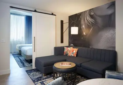 a living room with a couch and a bed at SERENA Hotel Aventura Miami, Tapestry Collection by Hilton in Aventura