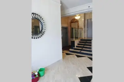 a hallway with stairs and a mirror on the wall at OCEAN FRONT BEACH PADS---South Beach in Miami Beach