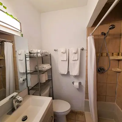 a bathroom with a toilet and a shower with towels at OCEAN FRONT BEACH PADS---South Beach in Miami Beach