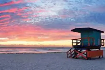 a lifeguard station on the beach at sunset at OCEAN FRONT BEACH PADS---South Beach in Miami Beach