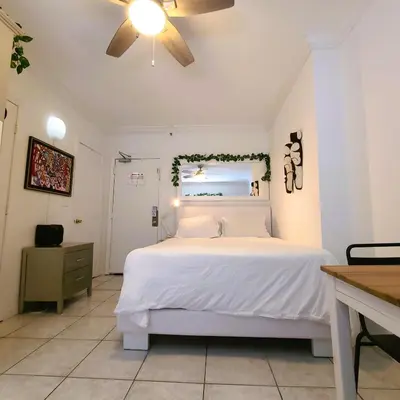 a bedroom with a white bed and a ceiling at OCEAN FRONT BEACH PADS---South Beach in Miami Beach