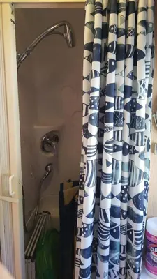 a shower curtain in a bathroom with a shower head at Airstream in the Center of it All in Miami