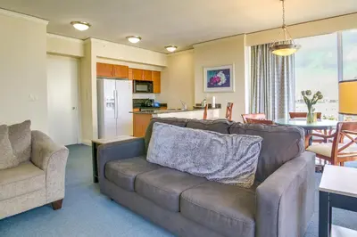 a living room with a couch and a kitchen at Pool and Tennis Beachfront Florida Condo! in Miami Beach