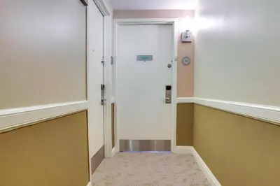 an empty hallway with a door and a hallwayngth at Pool and Tennis Beachfront Florida Condo! in Miami Beach