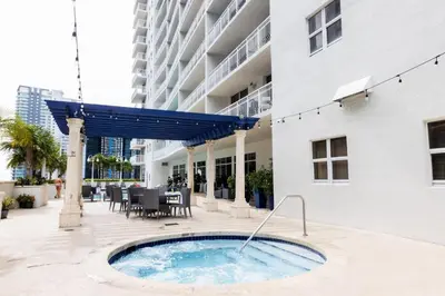 a hot tub in the courtyard of a building at Modern and Luxurious Brickell Studio in Miami