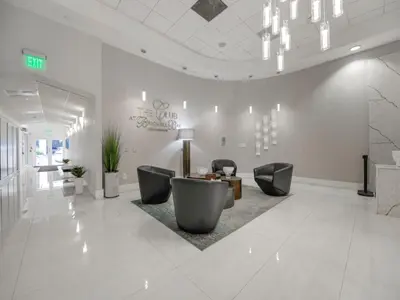 a lobby with chairs and a table in a building at Cozy and Bohemian Studio in Brickell in Miami