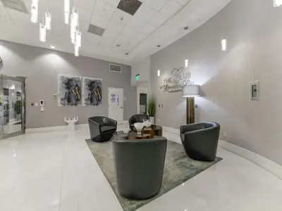a lobby with chairs and a table in a room at Cozy and Bohemian Studio in Brickell in Miami