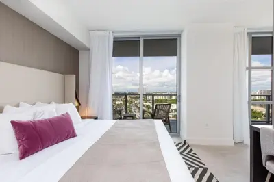 a bedroom with a large bed with a large window at Hyde Beach House Luxury Condo-Resort condo in Hollywood Beach