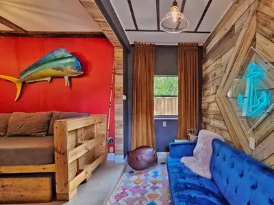 a bedroom with a bed and a fish painting on the wall at The Rum Locker - 1 King - 2 Twins - Private home and Patio - Sleeps 4 in Fort Lauderdale