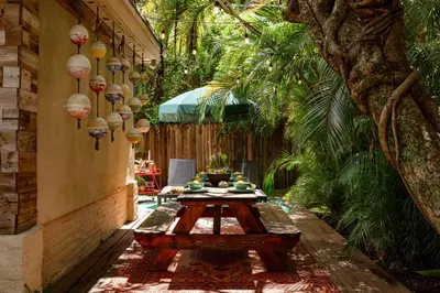 a patio with a table and a tree at The Rum Locker - 1 King - 2 Twins - Private home and Patio - Sleeps 4 in Fort Lauderdale