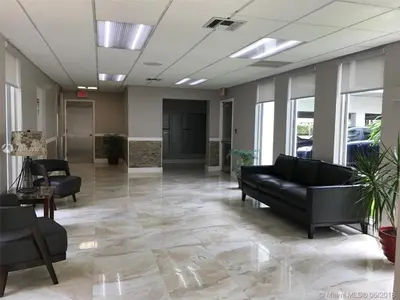 a lobby with couches and chairs in a building at Walk to the Beach at Sunny Isles in Miami Beach