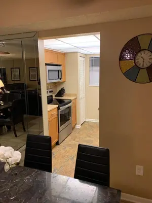 a kitchen and dining room with a table and chairs at Walk to the Beach at Sunny Isles in Miami Beach