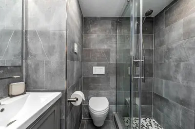 a bathroom with a toilet and a glass shower at AMAZING 2BR 2BA NEWLY RENO BEACHFRONT APT W/BEACH VIEW in Hollywood
