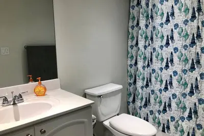 a bathroom with a sink and a toilet and a shower curtain at Spacious 1BR on the Beach, The Tides, Hollywood,FL in Hollywood