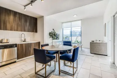 a kitchen and dining room with a table and chairs at Sentral Wynwood in Miami