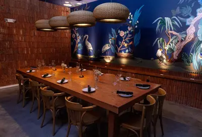 a large wooden table in a room with chairs at Sentral Wynwood in Miami