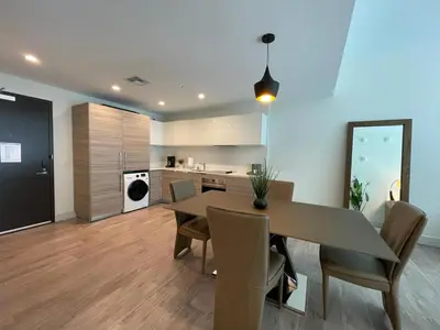 a kitchen and dining room with a table and chairs at COSTA HOLLYWOOD Steps to Beach in Hollywood