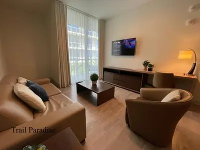 a living room with a couch and a chair and a tv at COSTA HOLLYWOOD Steps to Beach in Hollywood