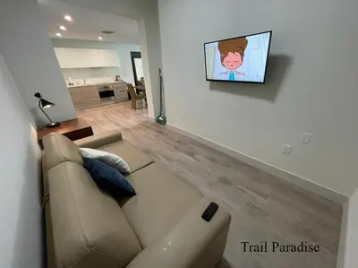 a living room with a couch and a tv on a wall at COSTA HOLLYWOOD Steps to Beach in Hollywood