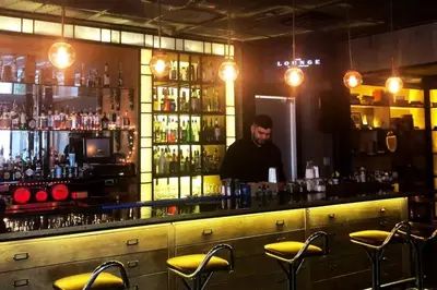 a man standing behind a bar in a bar at Downtown Miami Brickell Bay & Pool View 4 Bedrooms in Miami