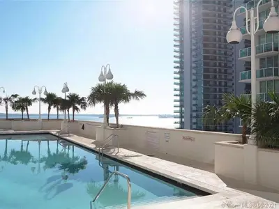 a swimming pool with a view of the ocean at Downtown Miami Brickell Bay & Pool View 4 Bedrooms in Miami