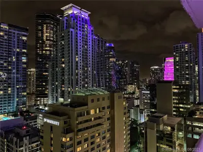 a city skyline at night with purple lights at Downtown Miami Brickell Bay & Pool View 4 Bedrooms in Miami