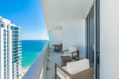 a room with a view of the ocean from a balcony at Hyde Beach Luxury Condo-Resort condo in Hollywood Beach