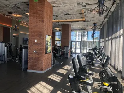 a gym with treadmills and exercise bikes in a room at HYDE HOUSE 1906 HALLENDER MIAMI in Hollywood
