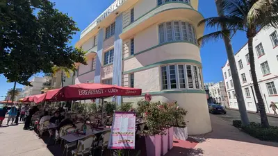 a street with tables and chairs in front of a building at *530 BEACH PAD-OCEAN DRIVE* in Miami Beach