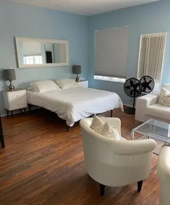 a bedroom with a bed and a chair and a couch at *530 BEACH PAD-OCEAN DRIVE* in Miami Beach