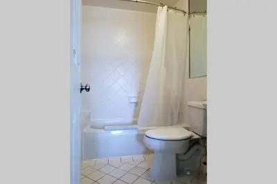 a bathroom with a toilet and a bath tub at *530 BEACH PAD-OCEAN DRIVE* in Miami Beach
