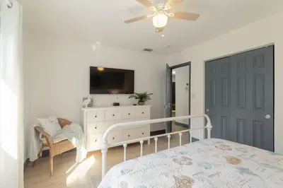 a bedroom with a bed and a dresser and a tv at Casa Madeira 2@ the heart of Miami Design District in Miami