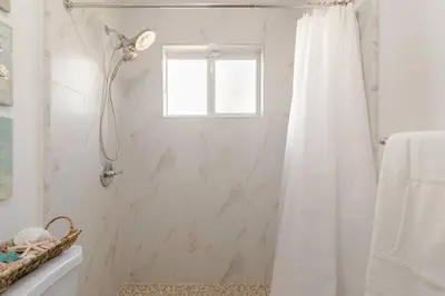 a white bathroom with a shower with a window at Casa Madeira 2@ the heart of Miami Design District in Miami
