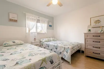 a bedroom with two beds and a dresser at Casa Madeira 2@ the heart of Miami Design District in Miami