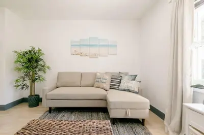 a living room with a couch and a rug at Casa Madeira 2@ the heart of Miami Design District in Miami