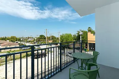 a balcony with a table and a view of a street at Roami at Grove 27 in Miami