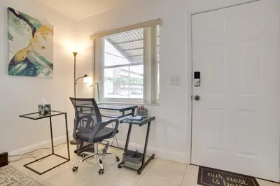 a room with a desk and a chair and a window at 2 Mi to Boardwalk Home with Grill in Dania Beach! in Dania Beach