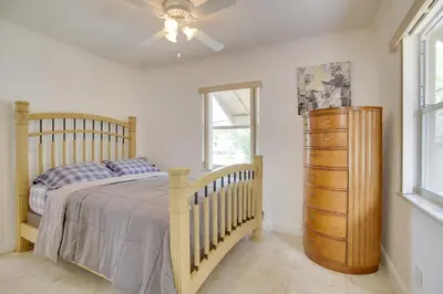 a bedroom with a bed and a ceiling fan at 2 Mi to Boardwalk Home with Grill in Dania Beach! in Dania Beach