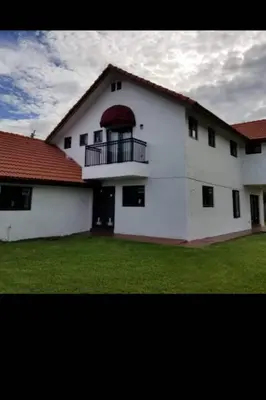 a white building with a balcony and a red roof at Spanish Style House - Free Parking in Miami