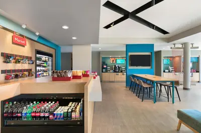 a restaurant with a drink bar and a table and chairs at avid hotel - Ft Lauderdale Airport - Cruise by IHG in Fort Lauderdale