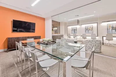 a dining room with a glass table and chairs at Luxury 2BD Apartment in Downtown Doral in Miami