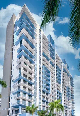 a tall building with palm trees in front of it at Luxury 2BD Apartment in Downtown Doral in Miami