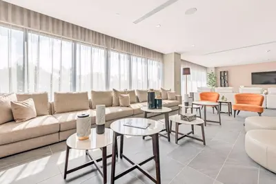 a living room with a couch and tables and chairs at Luxury 2BD Apartment in Downtown Doral in Miami