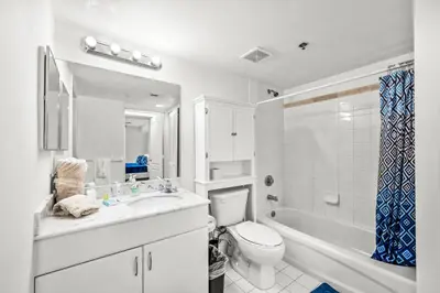 a white bathroom with a toilet and a tub and a sink at Luxury 1 Bedroom Apartment • Brickell • City and Ocean View in Miami