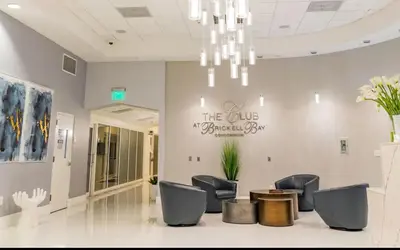 a waiting room with chairs and a sign on the wall at Luxury 1 Bedroom Apartment • Brickell • City and Ocean View in Miami
