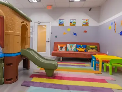 a childrens play room with a couch and a slide at Luxury 1 Bedroom Apartment • Brickell • City and Ocean View in Miami