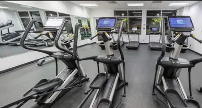a gym with rows of treadmills and cardio machines at Luxurious 1 Bed Apartment • Brickell • Ocean Views in Miami