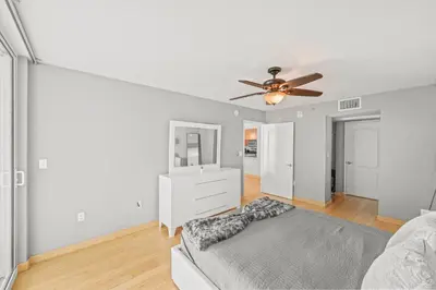 a living room with a ceiling fan and a couch at Luxurious 1 Bed Apartment • Brickell • Ocean Views in Miami