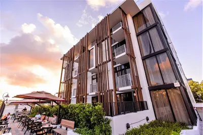 a building with tables and chairs in front of it at Upsun Hotel in Miami Beach