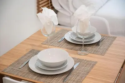 a table with plates and bowls and glasses on it at Casa Del Mar Master in Hollywood